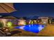 Backyard features a luxurious pool with fountains, umbrella, patio furniture, and an outdoor fireplace at 20151 E Via Del Palo St, Queen Creek, AZ 85142