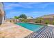 Backyard pool area surrounded by travertine patio, featuring lounge chairs, and a refreshing pool at 20151 E Via Del Palo St, Queen Creek, AZ 85142