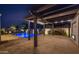 Backyard features a stunning pool with water fountains, an outdoor fireplace, and a covered patio area at 20151 E Via Del Palo St, Queen Creek, AZ 85142
