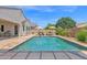 Private backyard pool with stone surround, lounge chairs and umbrellas at 20151 E Via Del Palo St, Queen Creek, AZ 85142
