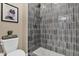 Tiled shower with a rainfall showerhead and mosaic flooring detail at 20151 E Via Del Palo St, Queen Creek, AZ 85142