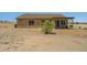 View of backyard showing desert landscape, patio and sliding glass doors at 21859 W Gail Dr, Buckeye, AZ 85326