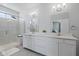 This bright bathroom features double sinks, modern fixtures, and a glass-enclosed shower at 21859 W Gail Dr, Buckeye, AZ 85326