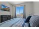 This bedroom features a large window and a TV mounted on the wall at 21859 W Gail Dr, Buckeye, AZ 85326