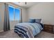 This sunny bedroom features plush carpeting, a ceiling fan, and a double bed at 21859 W Gail Dr, Buckeye, AZ 85326