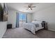 Cozy bedroom featuring a ceiling fan, carpet, and a window with natural light at 21859 W Gail Dr, Buckeye, AZ 85326