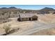 New home with a gravel driveway and desert landscaping. Mountain view in background at 21859 W Gail Dr, Buckeye, AZ 85326
