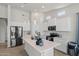 Bright kitchen with white cabinets, stainless steel appliances, an island with quartz countertops, and pendant lighting at 21859 W Gail Dr, Buckeye, AZ 85326