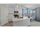 Bright eat-in kitchen boasts white cabinetry, quartz countertops, an island, and backyard views at 21859 W Gail Dr, Buckeye, AZ 85326