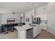 Bright kitchen featuring an island with sink and dishwasher, stainless steel appliances, and an adjoining living space at 21859 W Gail Dr, Buckeye, AZ 85326