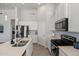 Bright kitchen showcasing white cabinets, stainless steel appliances, island with pendant lighting and tiled floor at 21859 W Gail Dr, Buckeye, AZ 85326