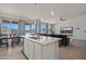 Open kitchen and living room with bar seating area, mountain views, stainless steel appliances, and gray accents at 21859 W Gail Dr, Buckeye, AZ 85326