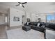 Bright living room showcasing gray sofa and white rug, connecting seamlessly with the kitchen and dining area at 21859 W Gail Dr, Buckeye, AZ 85326