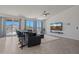 Modern living room with bar seating area, large windows that frame mountain views, and a wall-mounted TV at 21859 W Gail Dr, Buckeye, AZ 85326