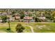 Expansive aerial view of a community home overlooking the golf course, complete with pool and lush landscaping at 2448 S Standage --, Mesa, AZ 85202