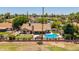 Backyard aerial view with a private pool, putting green, covered patio, and fenced yard at 2448 S Standage --, Mesa, AZ 85202