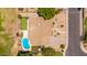 Aerial view of fenced backyard with a private pool, putting green, desert landscaping, and mature trees at 2448 S Standage --, Mesa, AZ 85202