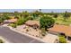Aerial view of a single story home with desert landscaping near a lush green golf course at 2448 S Standage --, Mesa, AZ 85202