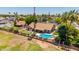 Backyard aerial view with a private pool, putting green, covered patio, and fenced yard at 2448 S Standage --, Mesa, AZ 85202