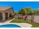Private backyard oasis with artificial grass, a charming swing, and well-maintained landscaping at 2448 S Standage --, Mesa, AZ 85202