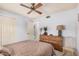Neutral colored bedroom with a ceiling fan, dresser, and lots of closet space at 2448 S Standage --, Mesa, AZ 85202