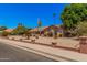 Charming single-story home featuring desert landscaping, brick accents, and mature palm trees at 2448 S Standage --, Mesa, AZ 85202
