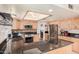 A spacious kitchen featuring stainless steel appliances, a kitchen island and wood cabinetry at 2448 S Standage --, Mesa, AZ 85202