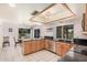 A modern kitchen featuring light wood cabinetry, dark countertops, and stainless steel appliances at 2448 S Standage --, Mesa, AZ 85202