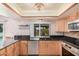 Bright kitchen with updated appliances, black countertops, and lots of natural light from the window at 2448 S Standage --, Mesa, AZ 85202