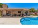 Covered patio with lounge chairs and outdoor dining area next to a sparkling pool at 2448 S Standage --, Mesa, AZ 85202