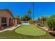 A perfect putting green in the back yard, complemented by a pool and mature landscaping at 2448 S Standage --, Mesa, AZ 85202