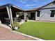 Landscaped backyard featuring a covered patio, artificial turf, and outdoor seating at 2715 E Canyon Creek Dr, Gilbert, AZ 85295