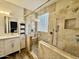 Stone tiled walk-in shower is the focal point of this well-appointed bathroom at 2715 E Canyon Creek Dr, Gilbert, AZ 85295
