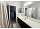 Bright bathroom featuring a large mirror, ample counter space, and access to a shower and an open doorway at 2715 E Canyon Creek Dr, Gilbert, AZ 85295
