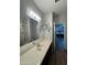 Bathroom with a large mirror, extended vanity, bathtub and shower combination, and a doorway that leads into the bedroom at 2715 E Canyon Creek Dr, Gilbert, AZ 85295