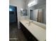 Bathroom featuring a large mirror, extended vanity with a white countertop, and a bathtub and shower combination at 2715 E Canyon Creek Dr, Gilbert, AZ 85295