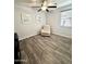 Bedroom with wood-look floors, ceiling fan, white walls, a recliner, and a window with blinds to control light at 2715 E Canyon Creek Dr, Gilbert, AZ 85295