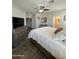 Bright bedroom with neutral walls, wood-look tile flooring, and a view to the ensuite bathroom at 2715 E Canyon Creek Dr, Gilbert, AZ 85295