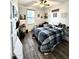 Bedroom featuring wood-look floors, natural light from a window, and walls adorned with decorative artwork at 2715 E Canyon Creek Dr, Gilbert, AZ 85295