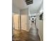 Hallway view leading to an arched entry into the kitchen with wood-look flooring and access to the bathroom and a bedroom at 2715 E Canyon Creek Dr, Gilbert, AZ 85295