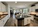 Open kitchen showcases white cabinetry, stainless steel appliances, and bar seating with a dining space at 2715 E Canyon Creek Dr, Gilbert, AZ 85295