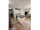 Open kitchen with island, stainless steel appliances, white cabinets, and view to living space at 2715 E Canyon Creek Dr, Gilbert, AZ 85295
