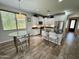 Bright kitchen with stainless steel appliances, white cabinets, a breakfast table and granite countertops at 2715 E Canyon Creek Dr, Gilbert, AZ 85295