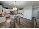 Bright kitchen with stainless steel appliances, white cabinets, and a glass dining table at 2715 E Canyon Creek Dr, Gilbert, AZ 85295