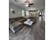 Open-concept living area with wood-look tile, neutral decor, and seamless flow into the kitchen at 2715 E Canyon Creek Dr, Gilbert, AZ 85295
