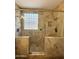 Enclosed shower with tile surround, glass enclosure, decorative glass block, and dual shower heads at 2715 E Canyon Creek Dr, Gilbert, AZ 85295