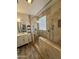 Walk-in shower with tile surround, glass door, showerhead, and a decorative glass block window at 2715 E Canyon Creek Dr, Gilbert, AZ 85295