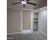 Bedroom with neutral walls, carpet, ceiling fan, and closet at 2946 N 14Th N St # 14, Phoenix, AZ 85014