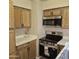 An efficient kitchen featuring stainless steel appliances and warm, wood cabinetry at 2946 N 14Th N St # 14, Phoenix, AZ 85014