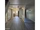 Open-concept living room with wood-look flooring and views of the kitchen and doorway at 2946 N 14Th N St # 14, Phoenix, AZ 85014